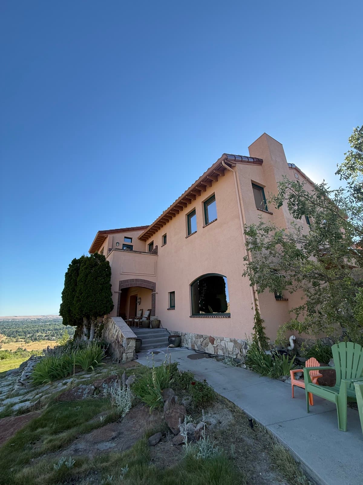 Mediterranean-style hillside home with a valley view