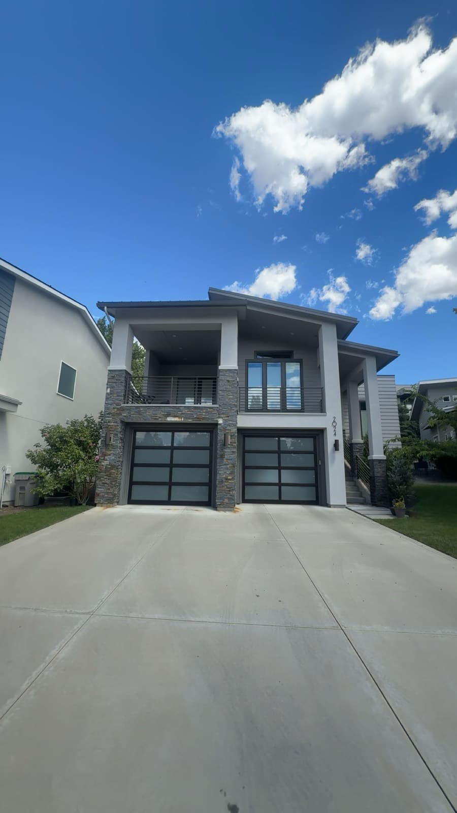 Contemporary gray home with a spotless driveway
