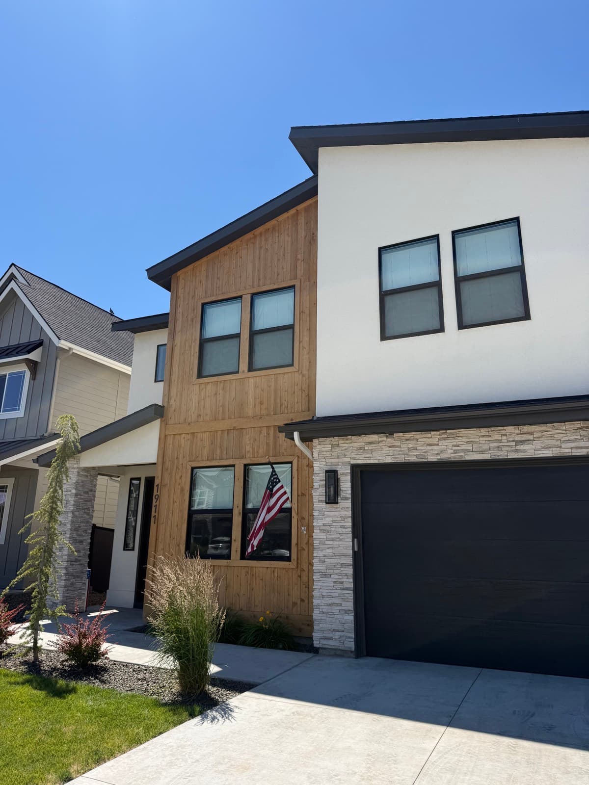Modern home with wood accents and a spotless garage-side
