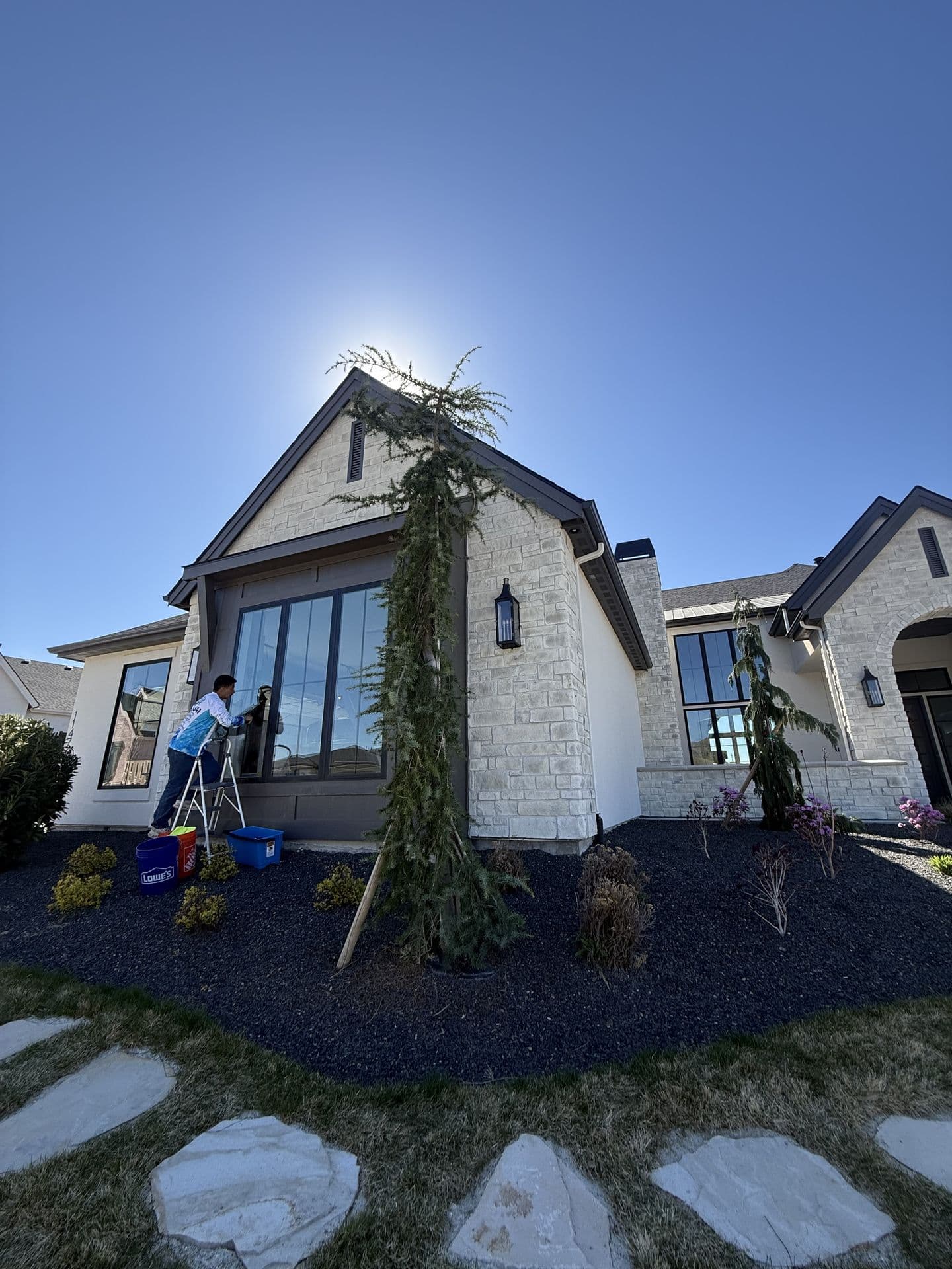 Pro Solutions technician detailing windows at a luxury Treasure Valley home