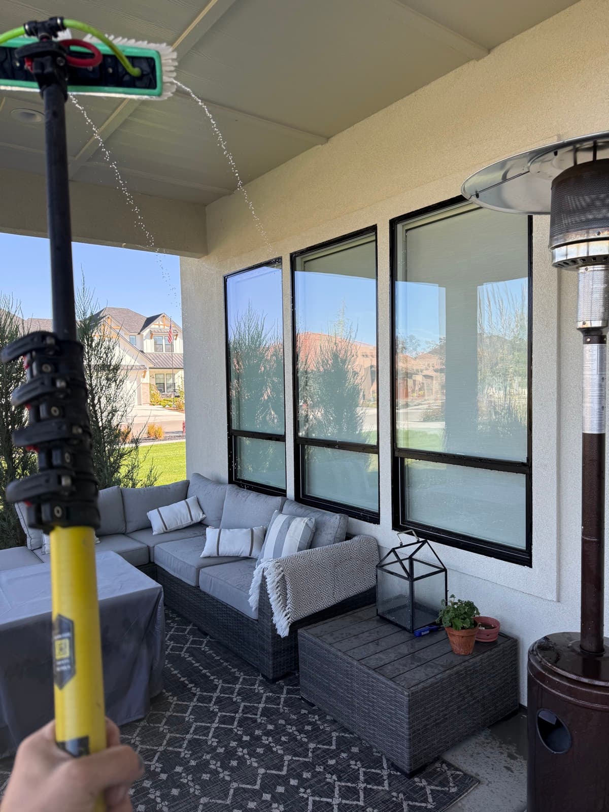 Water-fed pole cleaning covered-patio windows