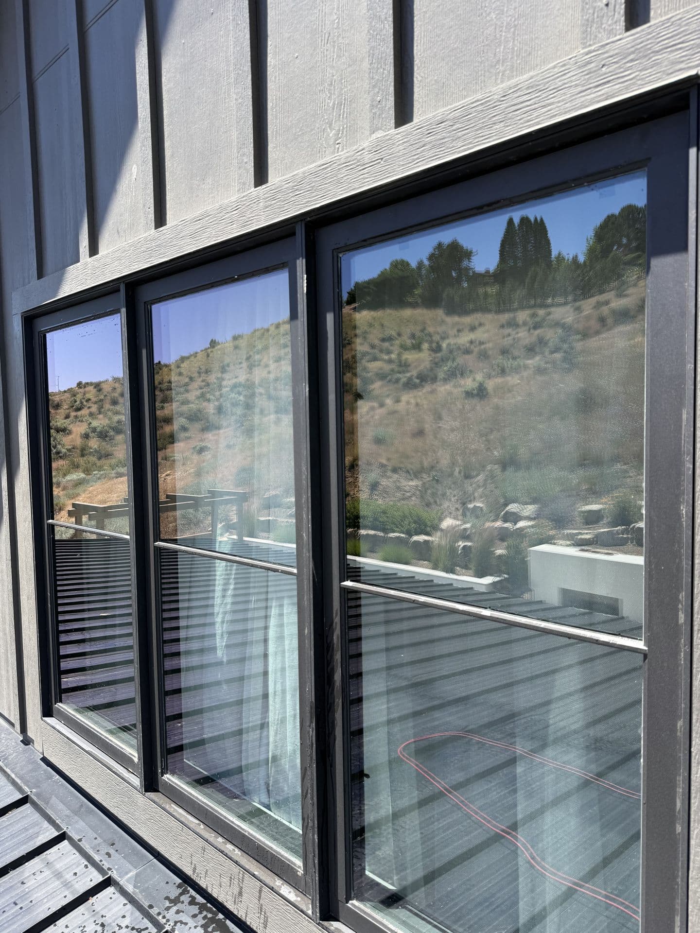 The same windows spotless, clearly reflecting the foothills