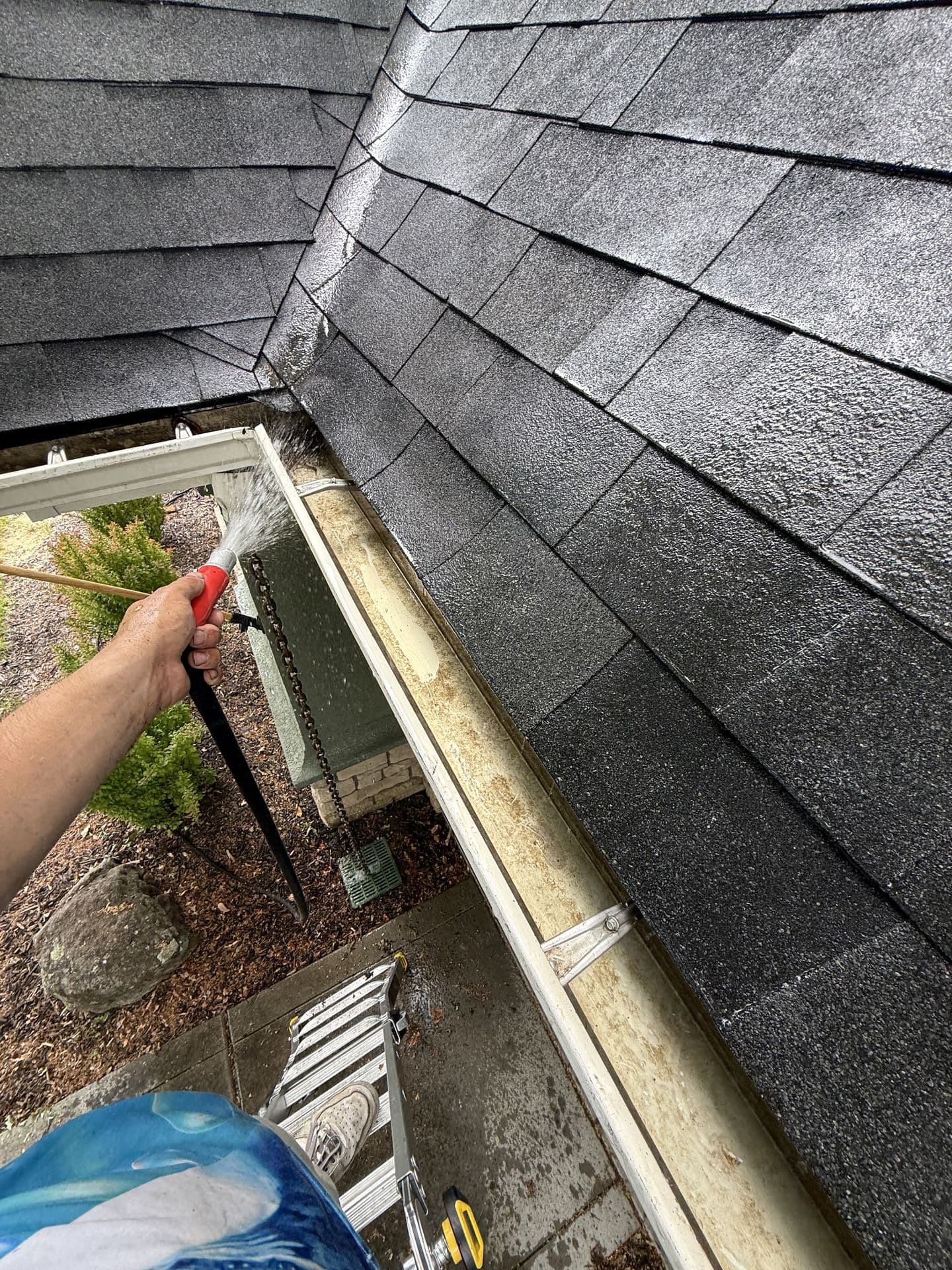 Downspout being flushed to confirm full flow โ gutter cleaning by Pro Solutions in the Treasure Valley