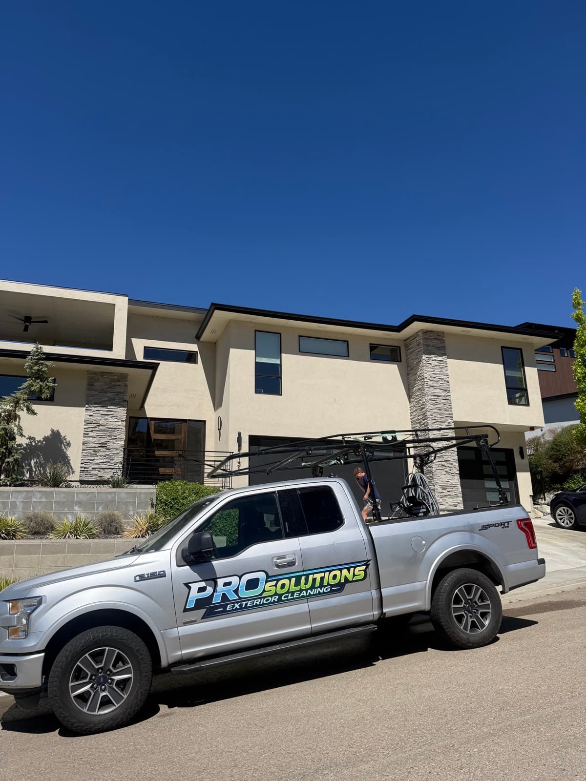 The Pro Solutions Exterior Cleaning wrapped work truck at a Boise home